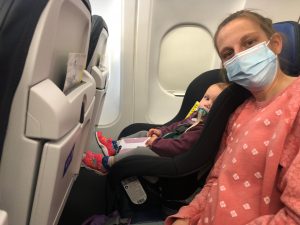 My daughter forward-facing in a car seat on an airplance