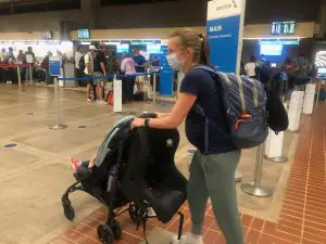 Carrying a car seat through the airport on a stroller